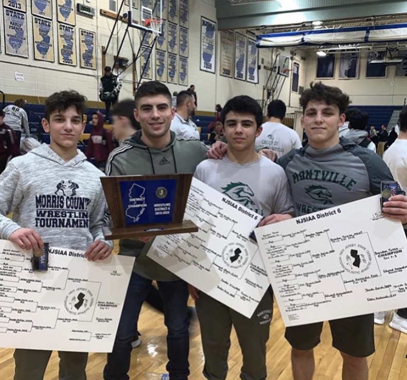 Este Built wrestlers on a tournament podium