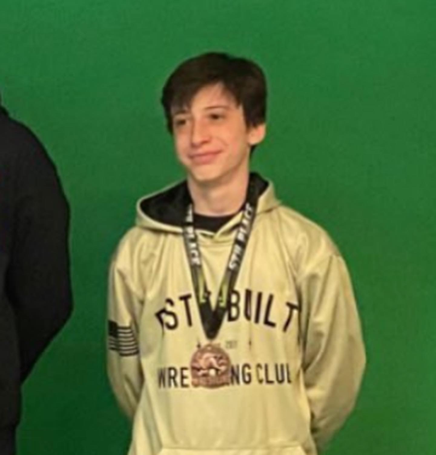 Este Built wrestler with a tournament medal