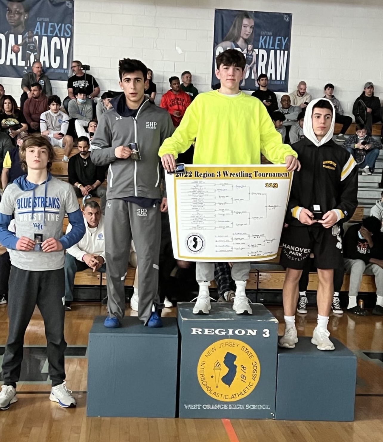 Este Built wrestler on a tournament podium