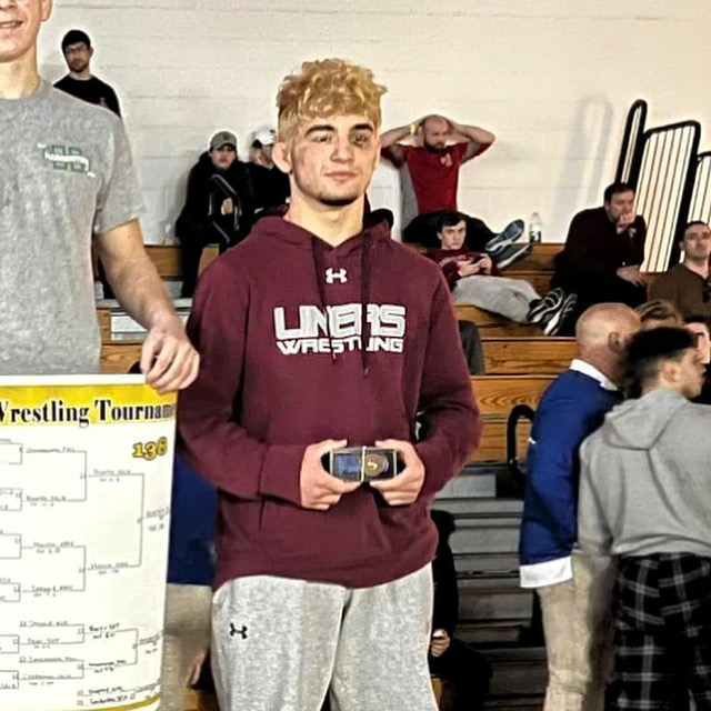Este Built wrestler celebrating after competing