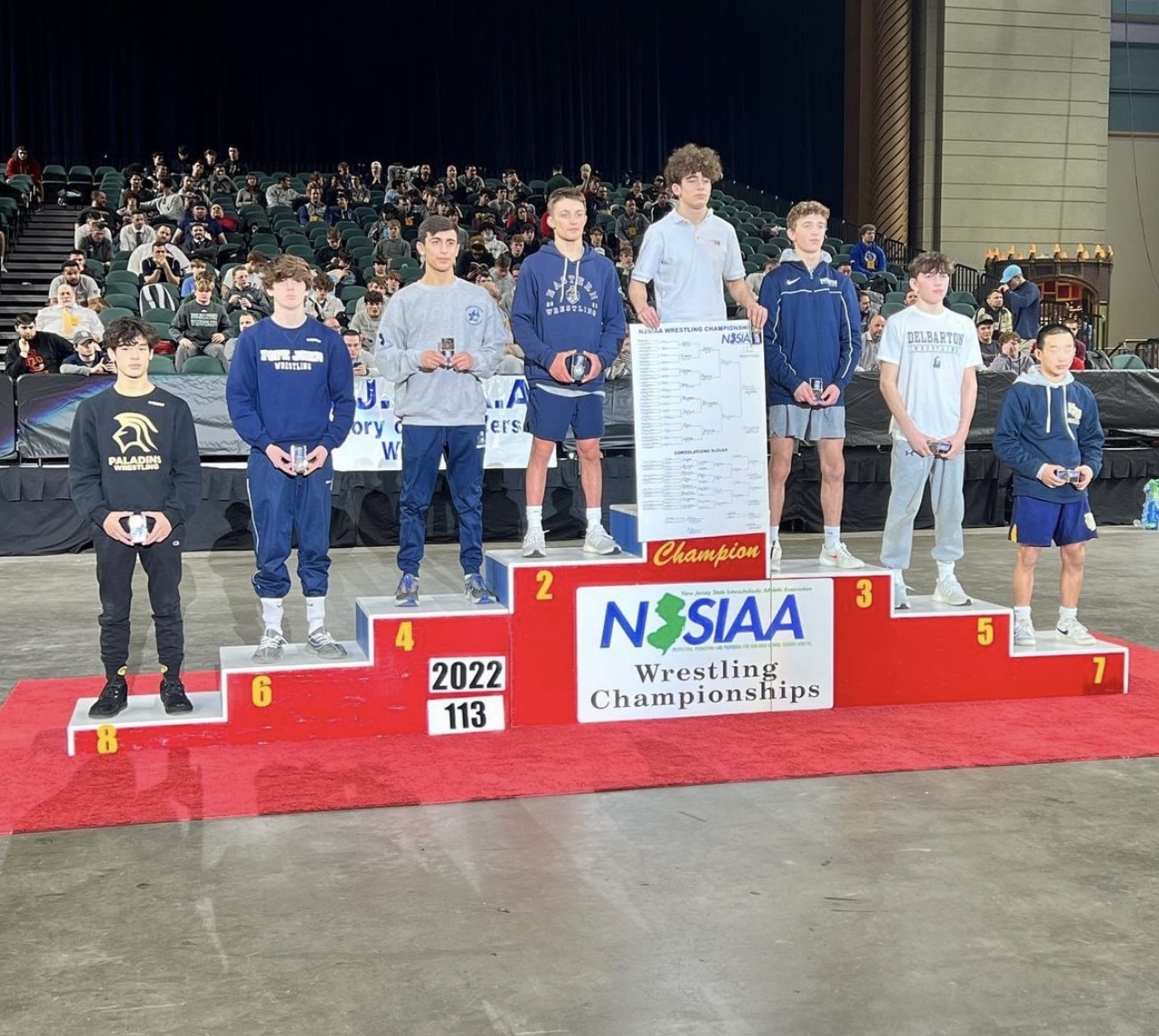 Este Built wrestlers on the podium at a tournament