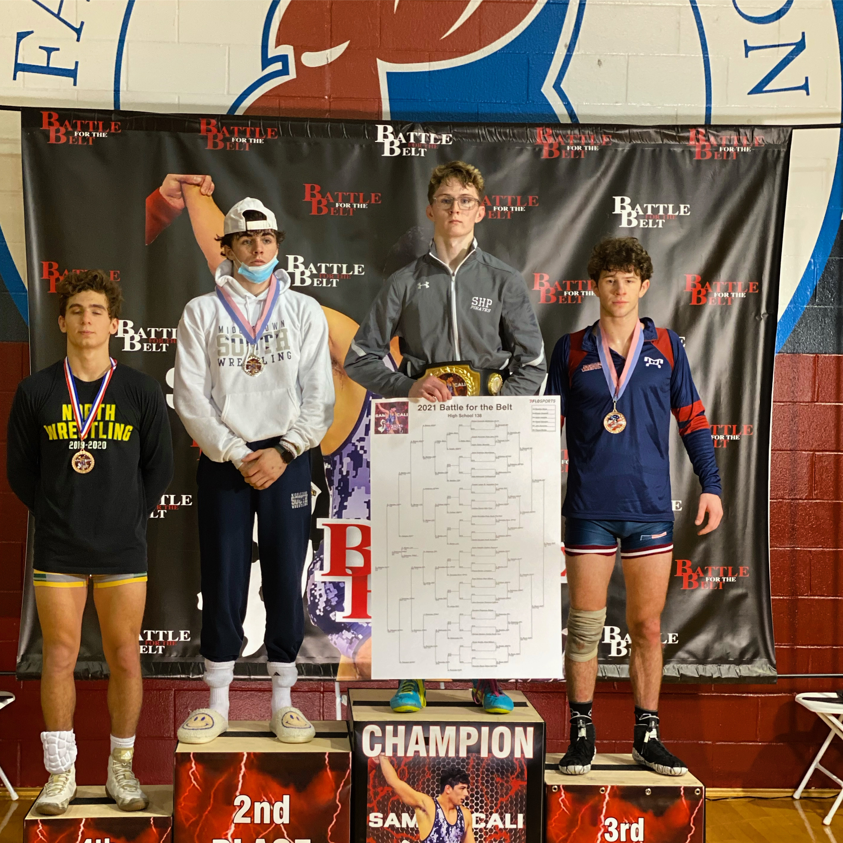 Este Built wrestler celebrating on the podium