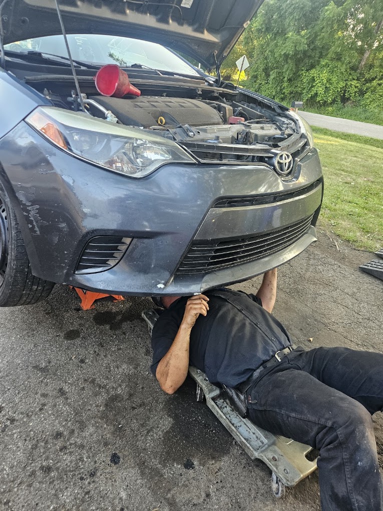 Caldwell Services mobile mechanic under a vehicle performing on-site service in New Castle PA