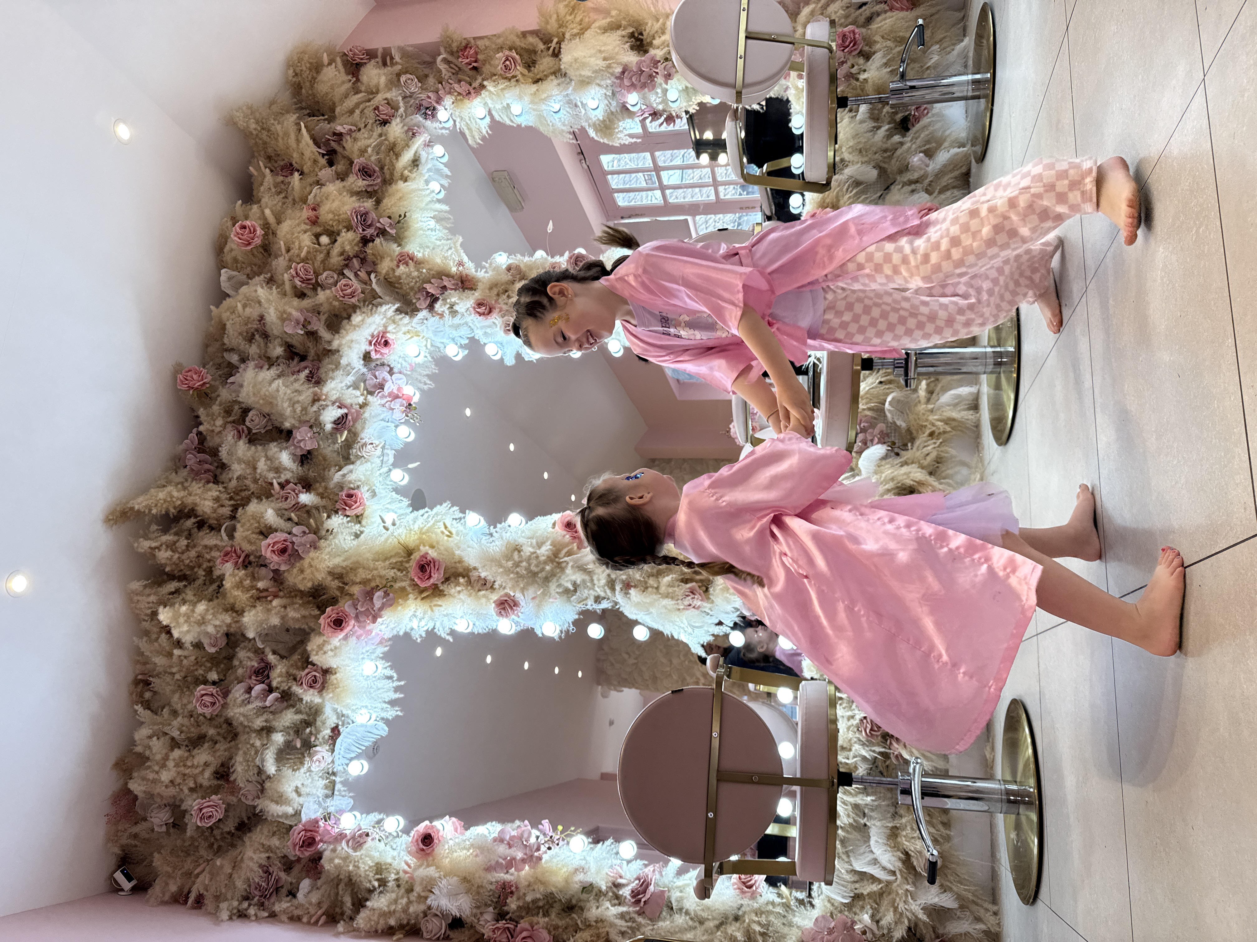 Little girls in pink silk robes and tiaras at Princess Pamper Party