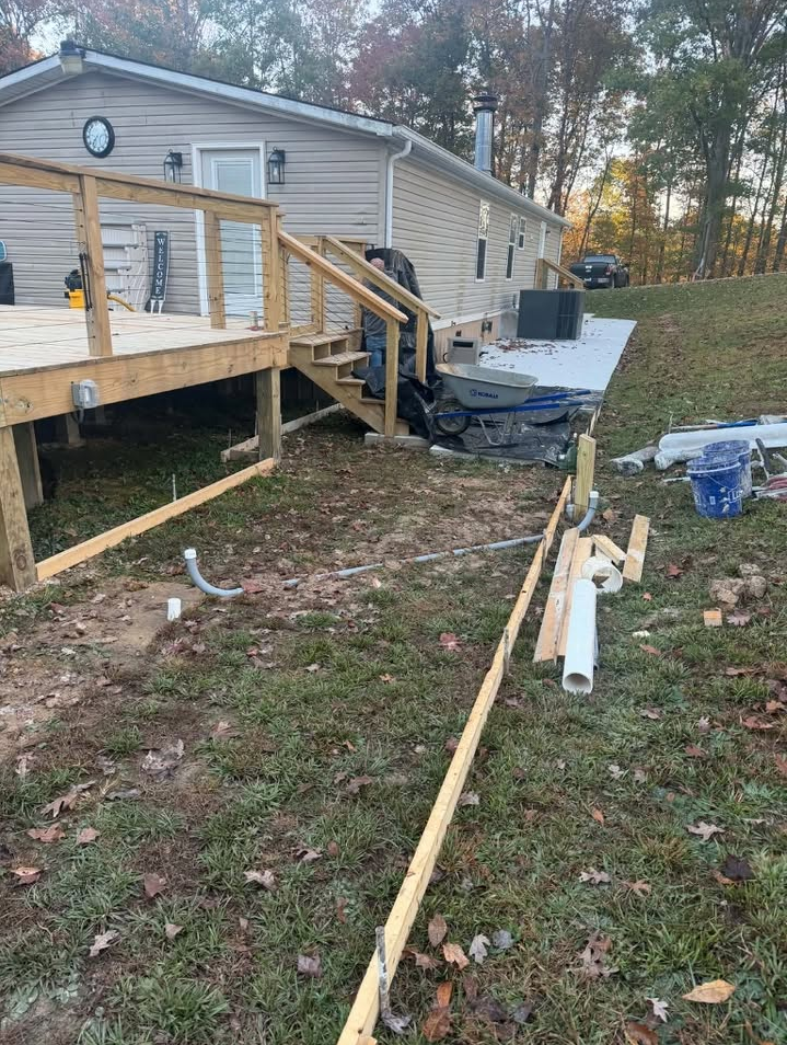 Walkway site preparation with wood framing forms before concrete pour