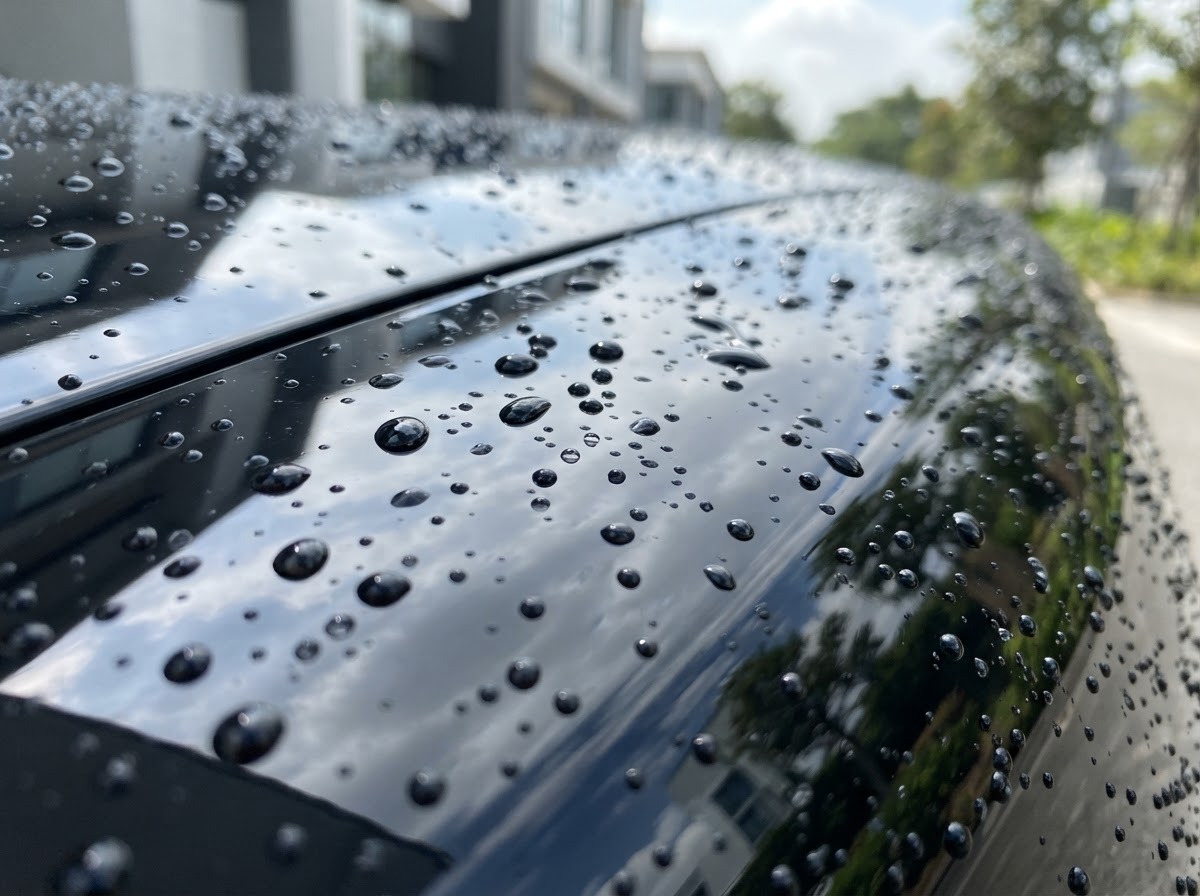 Glossy black car paint with deep mirror shine