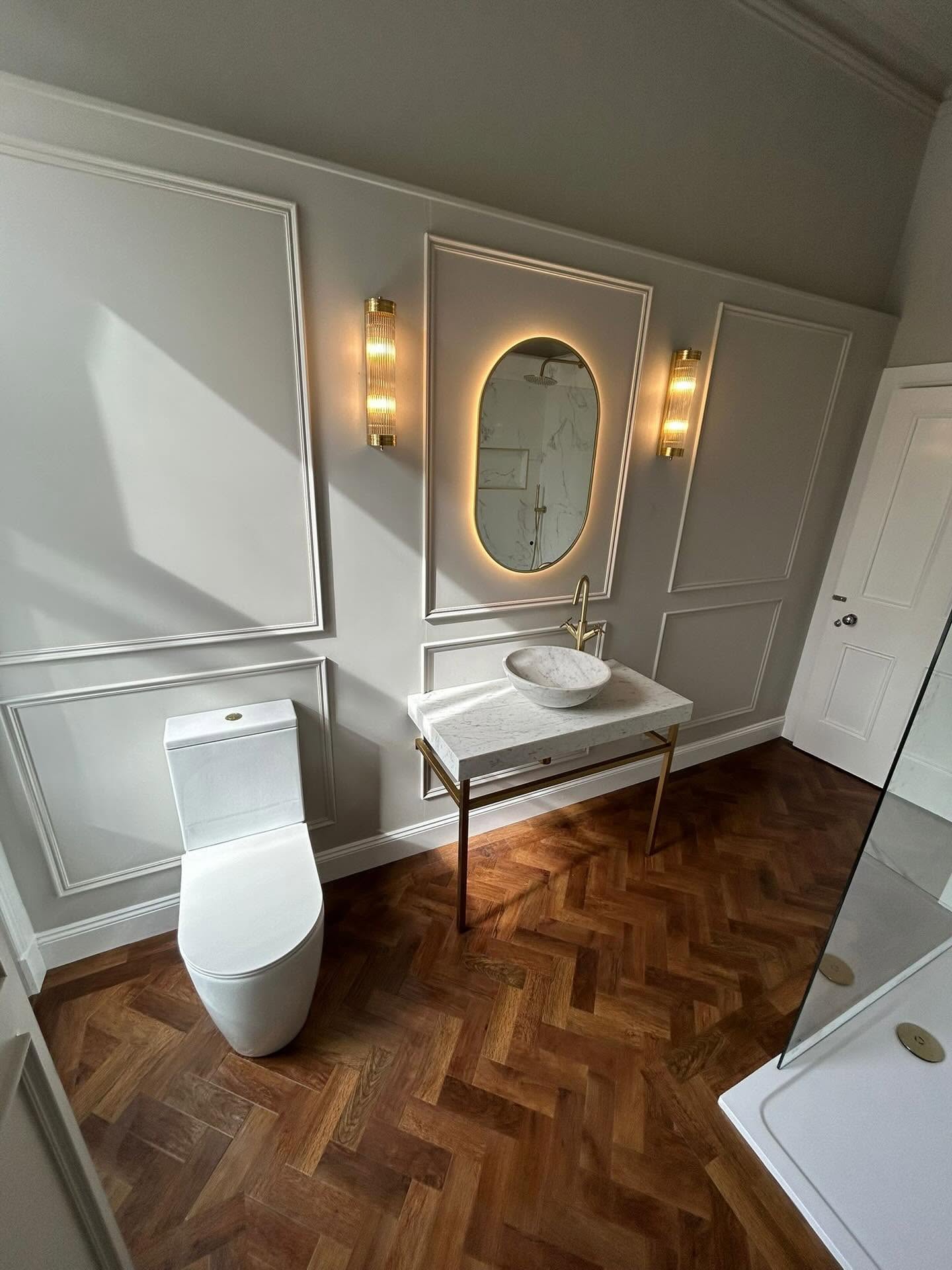 Heritage bathroom with herringbone parquet flooring and marble washstand in Kilbarchan