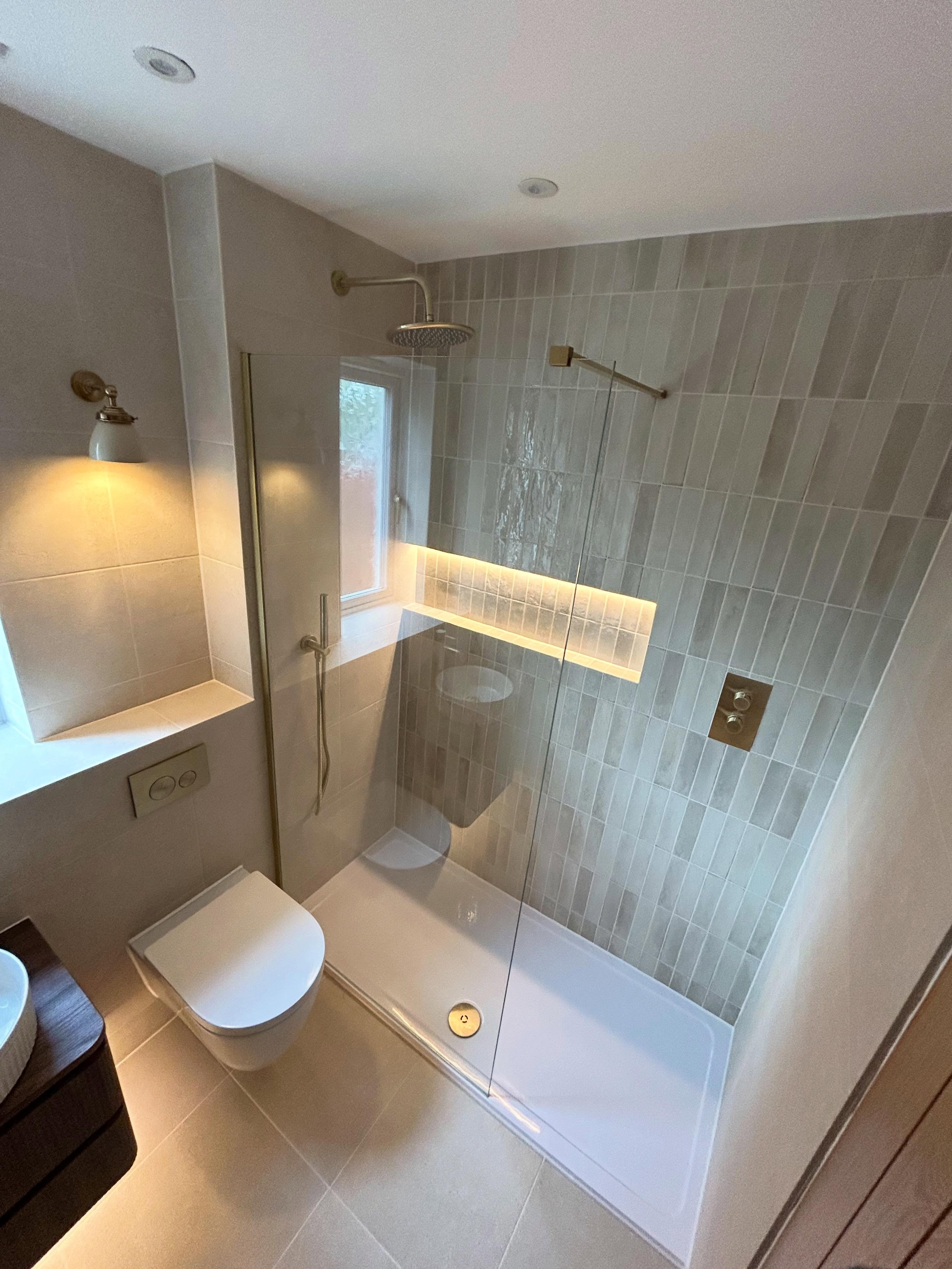 Walk-in shower with vertical kit-kat tiles and brushed brass rainfall shower in Erskine