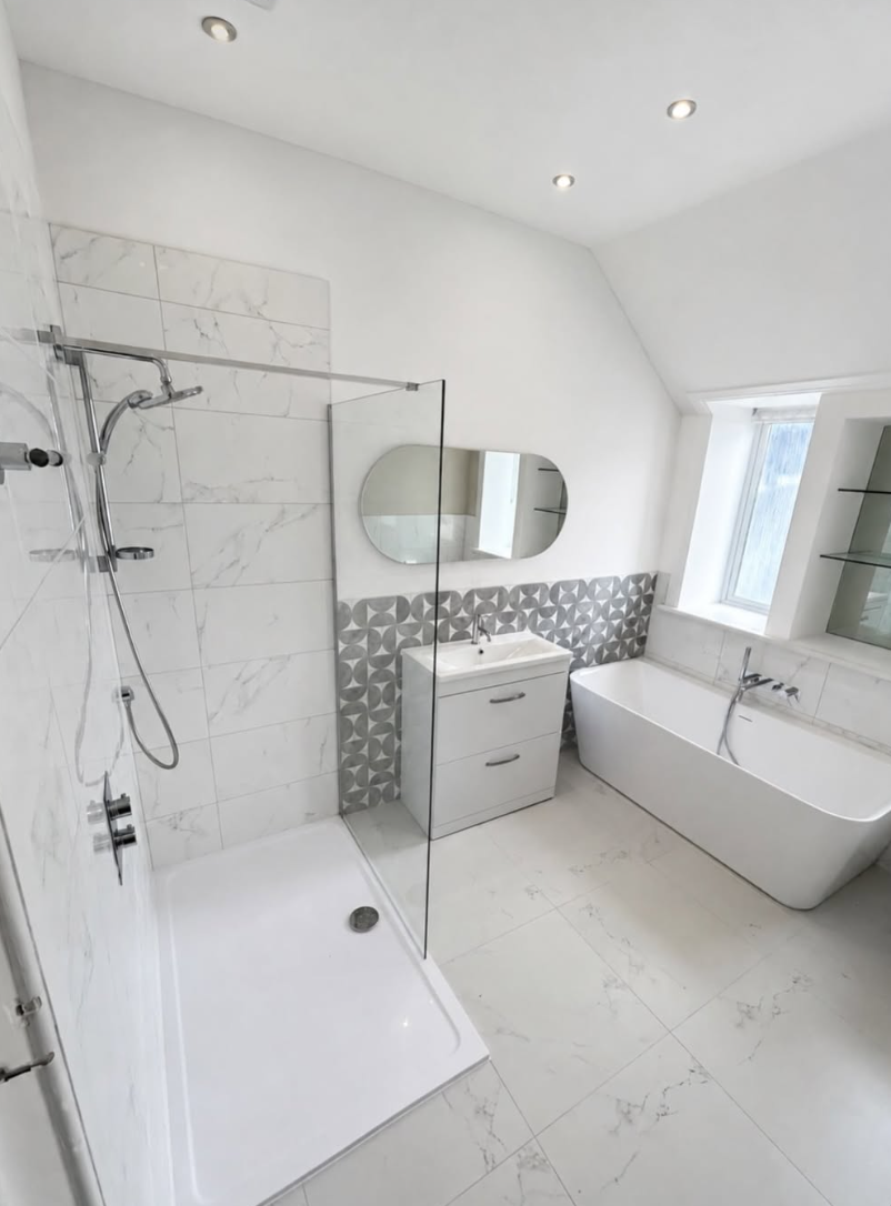 Bright attic bathroom with freestanding bath and walk-in marble shower in Linwood
