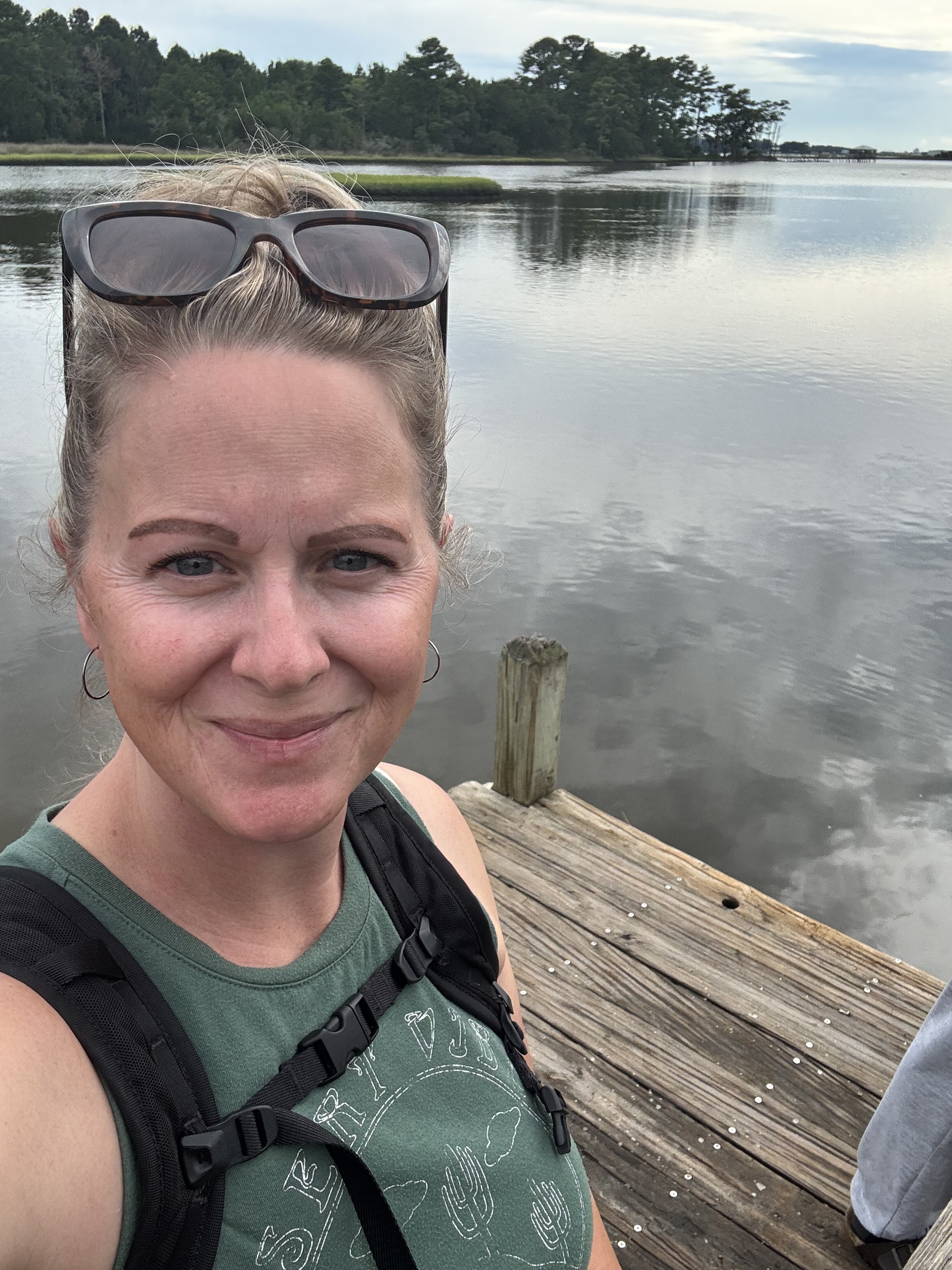 Carrie smiling by the water