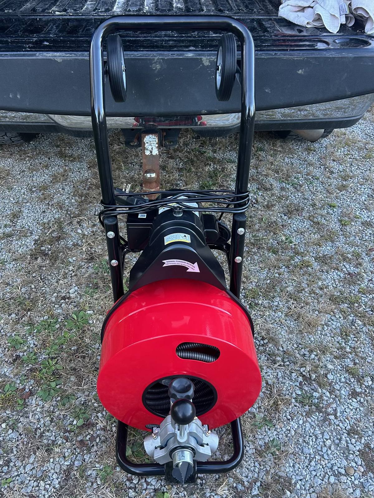 Professional motorized drain cleaning machine with red cable drum