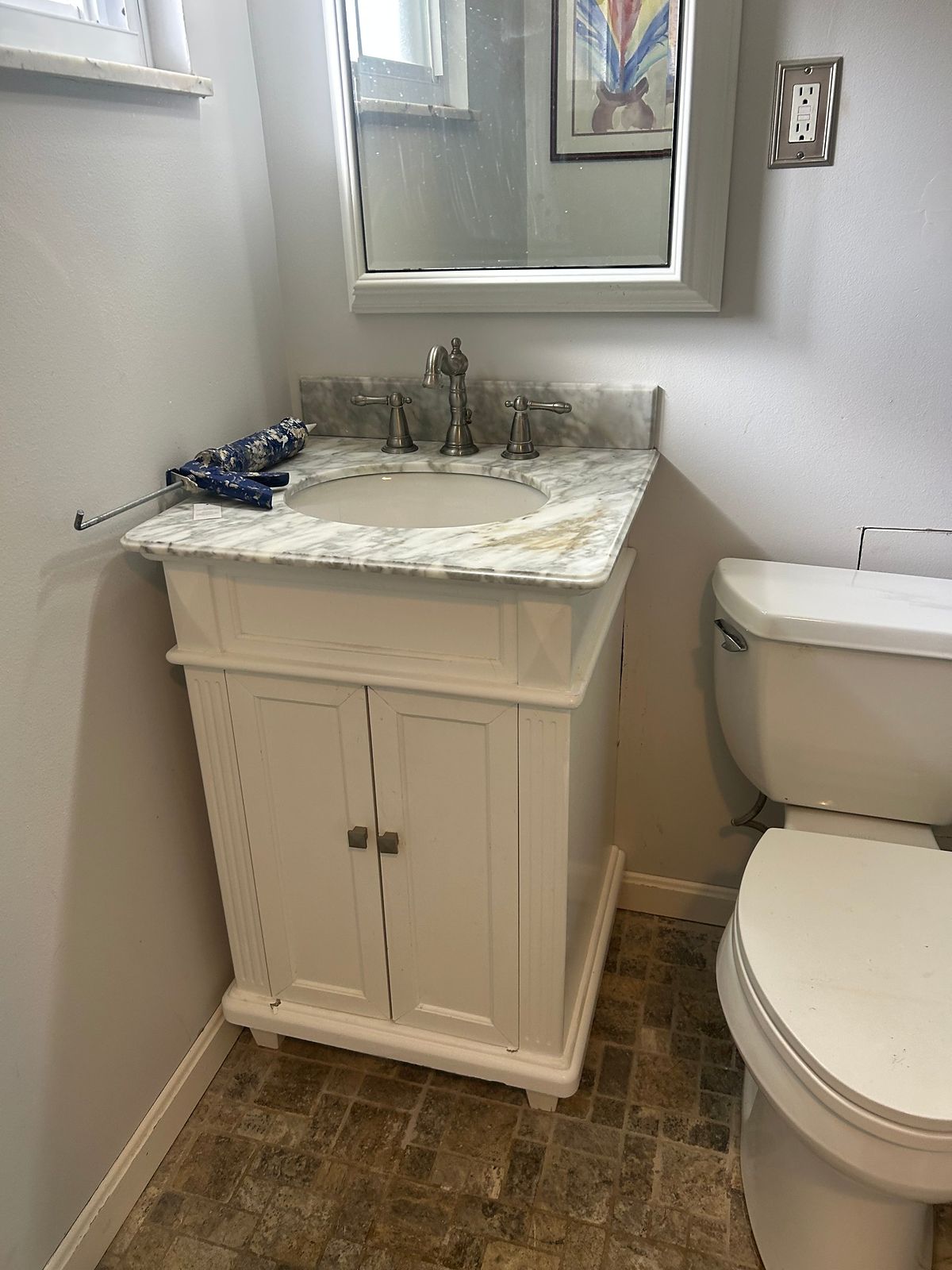 Bathroom vanity and sink back in place after the drain repair