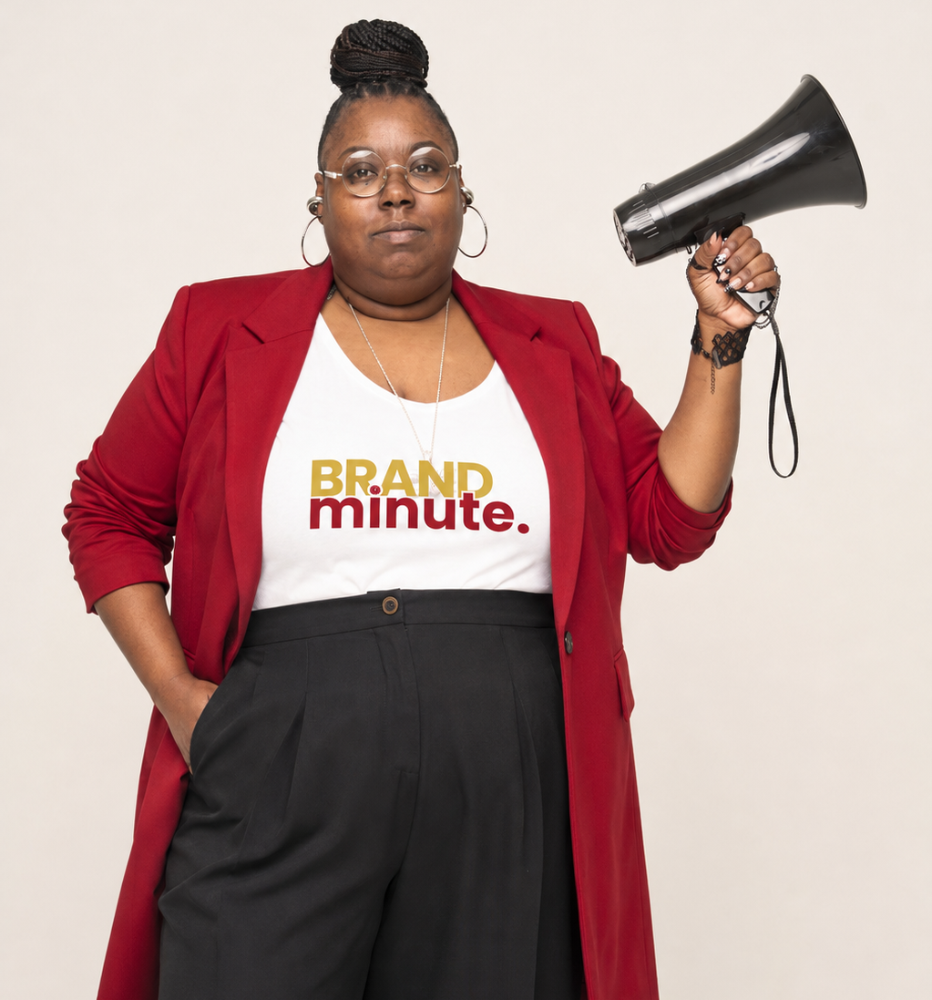 Amecha De'Sha, founder and creative strategist holding megaphone in Brand Minute shirt