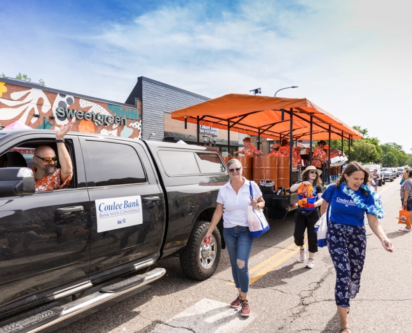 Tin Cups steel pan trailer moving through a cheerful parade crowd in Minnesota