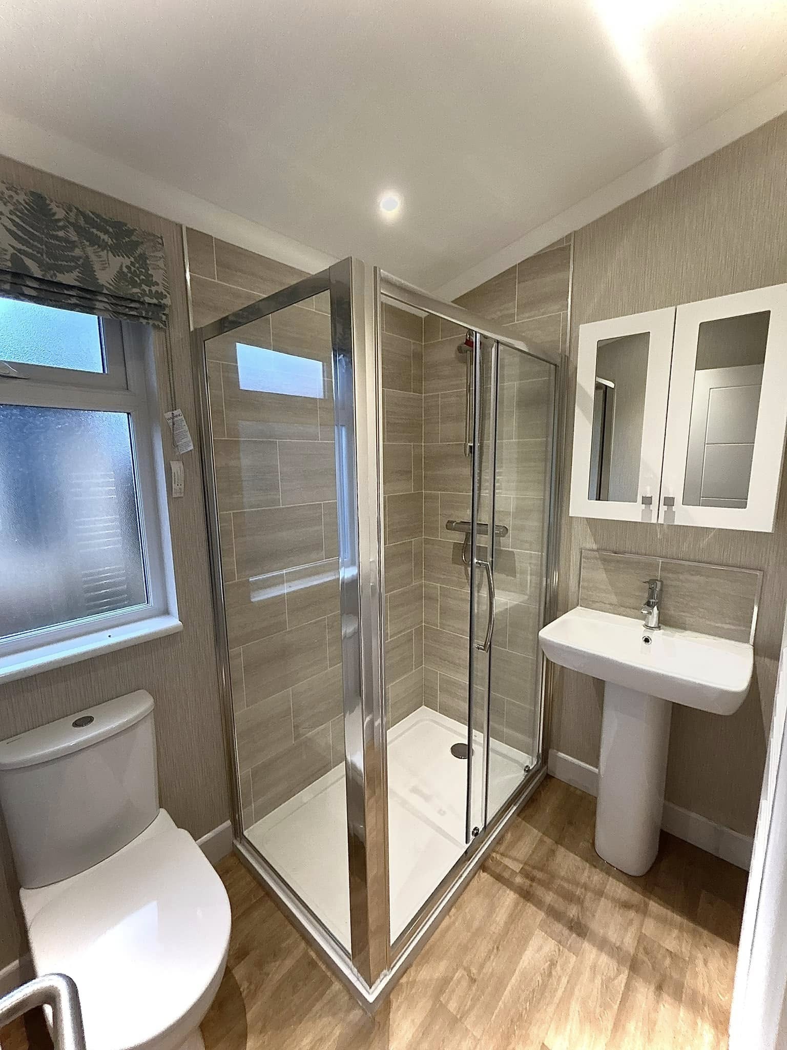 Luxury park home en-suite with walk-in corner glass shower and tiled surround