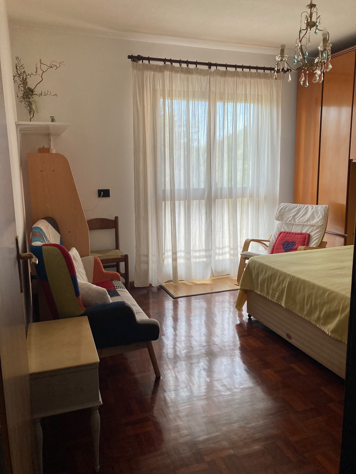 Guest bedroom with south-facing balcony at Renata's mountain apartment retreat