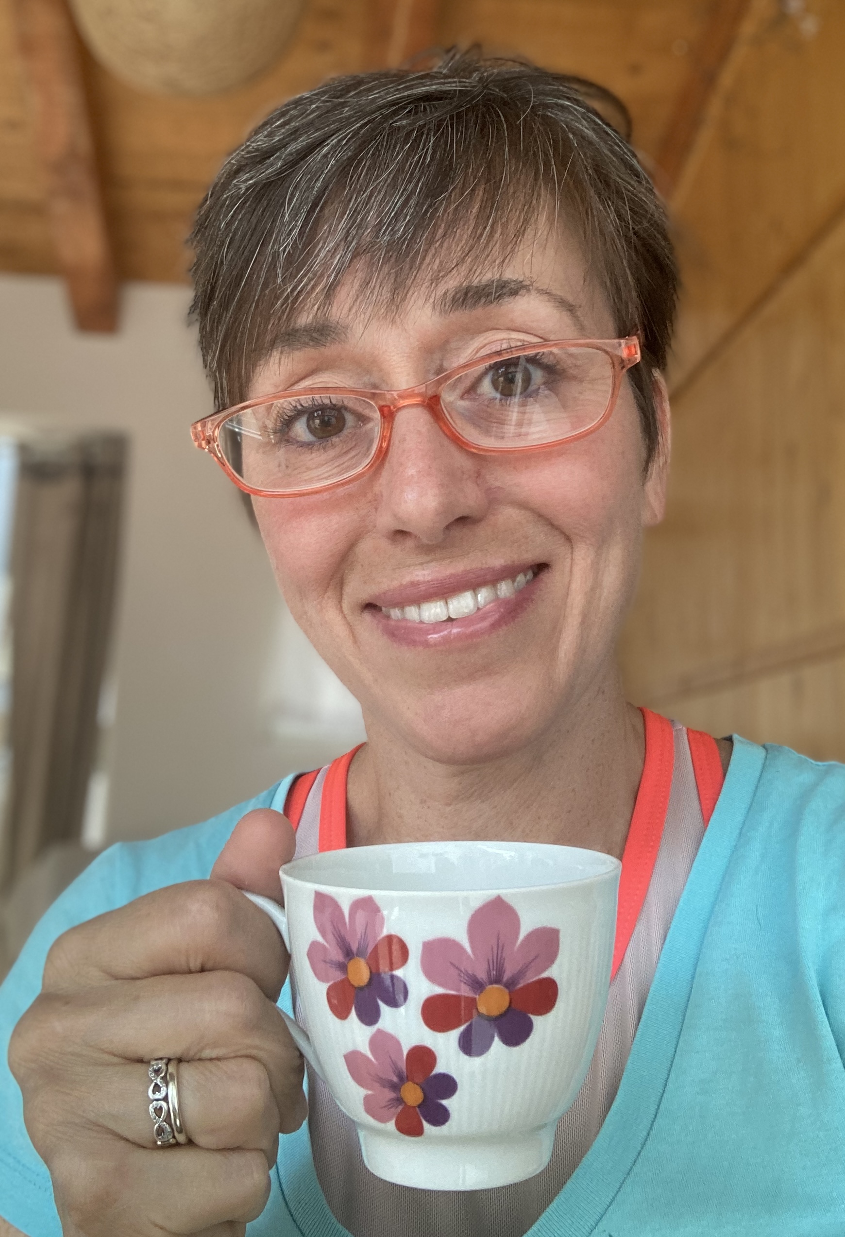 Portrait of Renata Perini smiling with a cup of tea