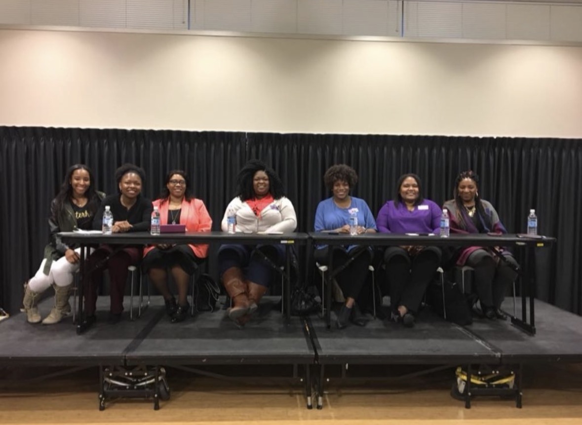 Tyra Steverson seated with fellow panelists at a campus leadership symposium