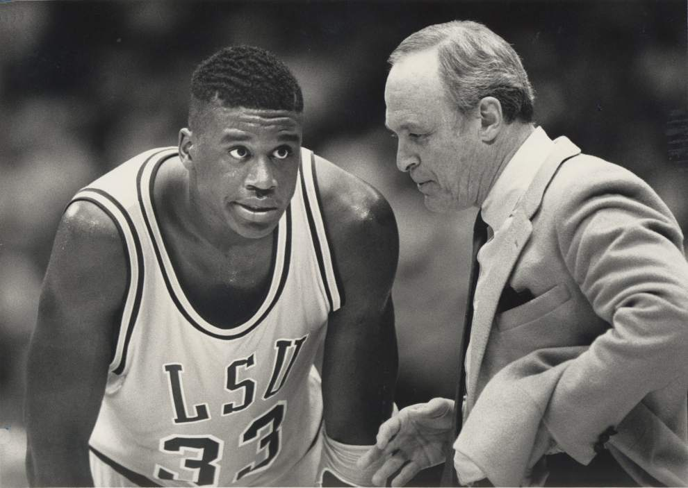 Coach Dale Brown speaking with LSU center Shaquille O'Neal (#33) on the sideline