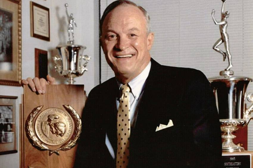 Coach Dale Brown holding the SEC Championship award