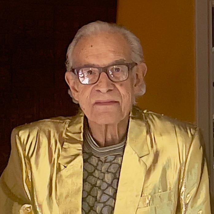Lanny in a shimmering golden jacket, radiating joy and personality