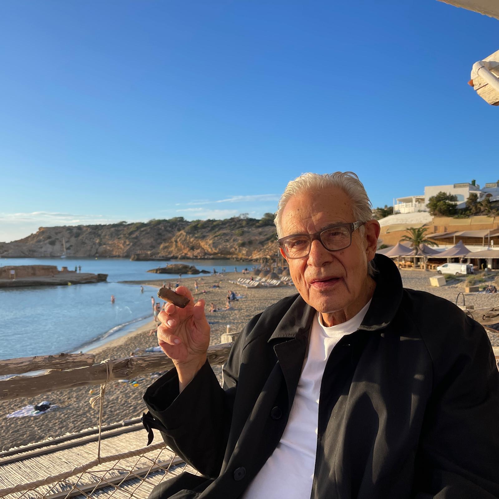 Dr. Leland (Lanny) Katz by the sea with a cigar under the golden Mediterranean light